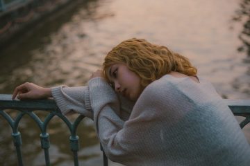 A person sleeping on a chair Description automatically generated with low confidence