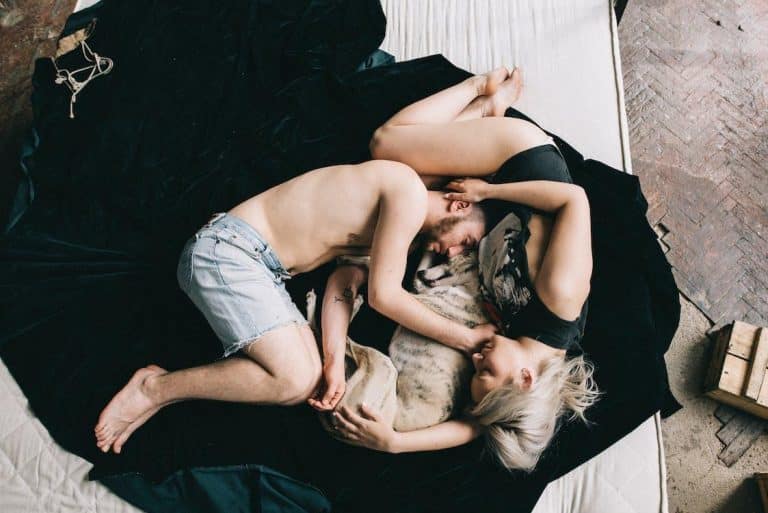Free Couple Sleeping With Pet Dog Stock Photo