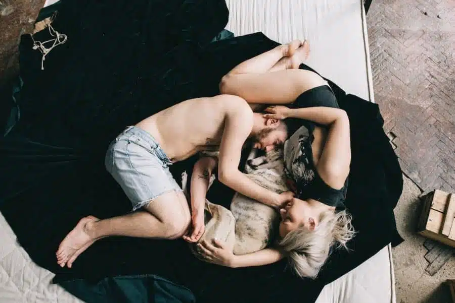 Free Couple Sleeping With Pet Dog Stock Photo